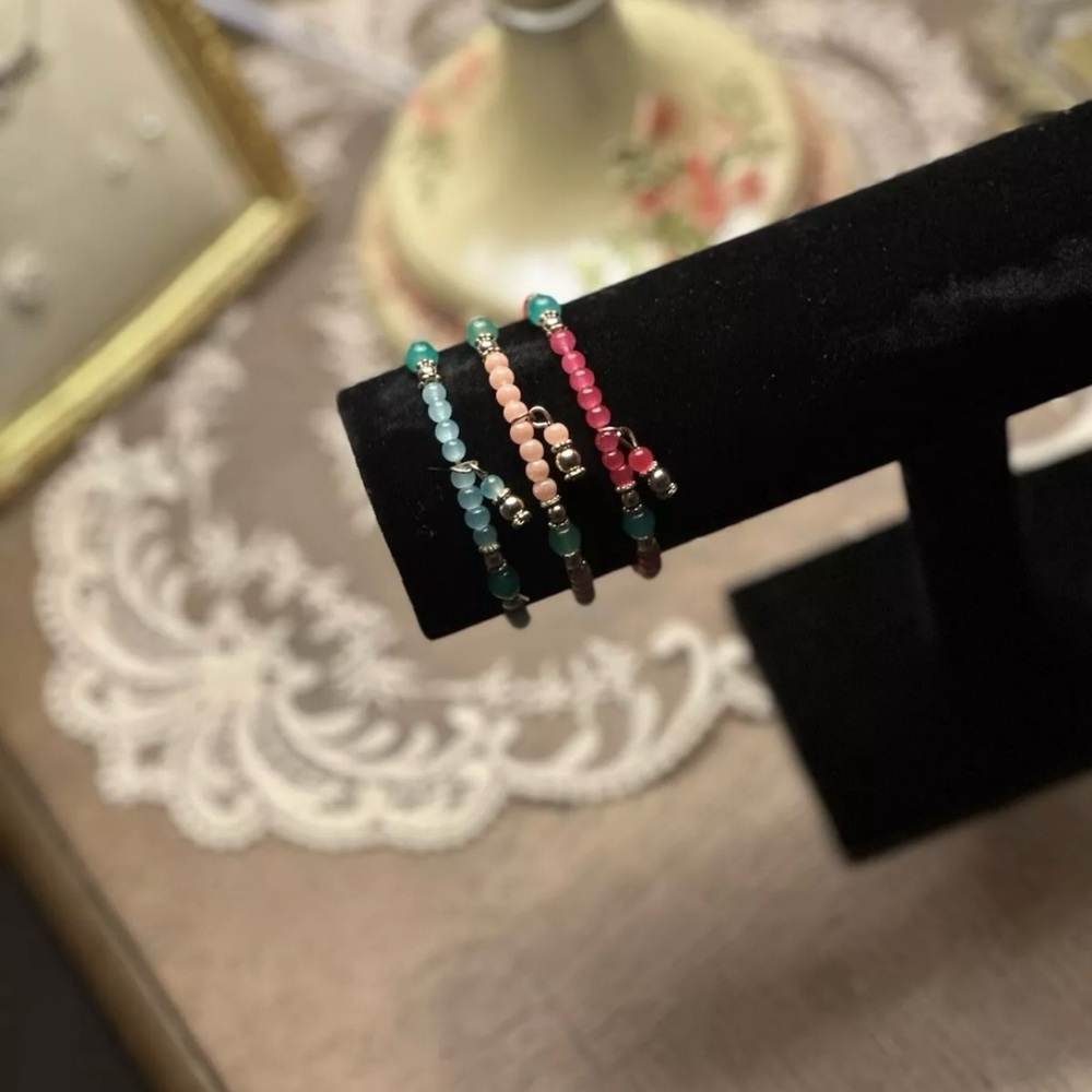 pink, light pink, and blue beaded bracelet.